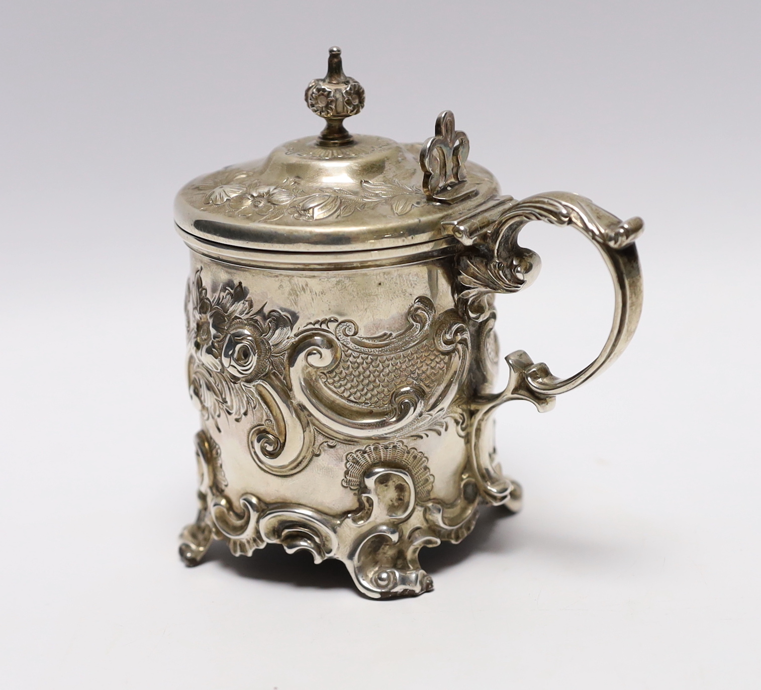 A Victorian embossed silver drum mustard, John Evans II, London, 1863, decorated with foliage and scrolls.